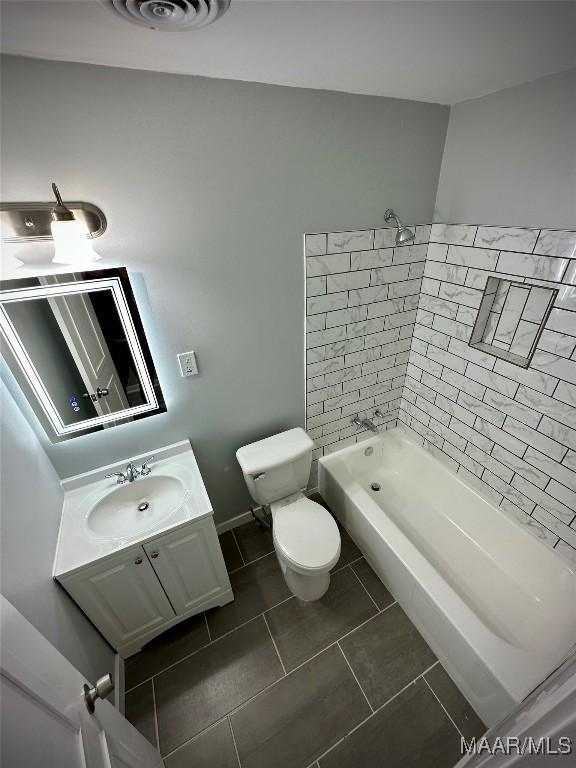 full bathroom with shower / tub combination, tile patterned flooring, toilet, visible vents, and vanity