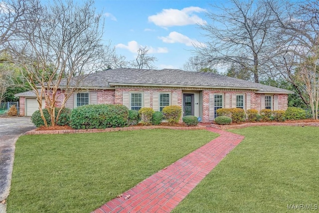 single story home featuring a garage, brick siding, and a front yard