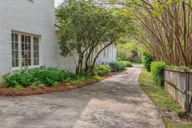 exterior space featuring fence and brick siding