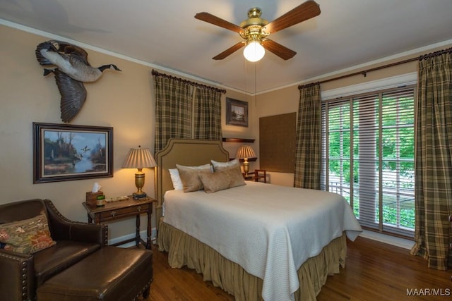 bedroom with multiple windows, wood finished floors, a ceiling fan, and crown molding