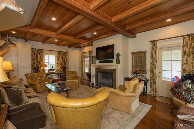 living room featuring dark wood-type flooring, wood ceiling, a fireplace with flush hearth, and beam ceiling