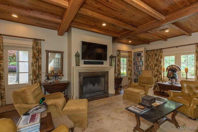 living room featuring wooden ceiling, beam ceiling, and a healthy amount of sunlight