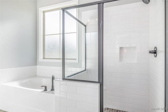 bathroom with a garden tub and a shower stall