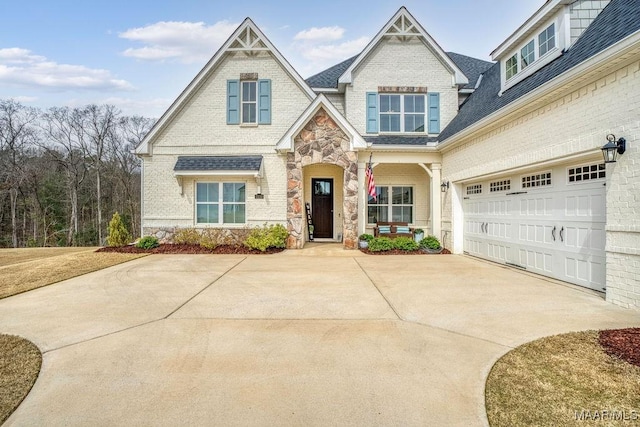 view of front facade featuring stone siding, brick siding, and driveway