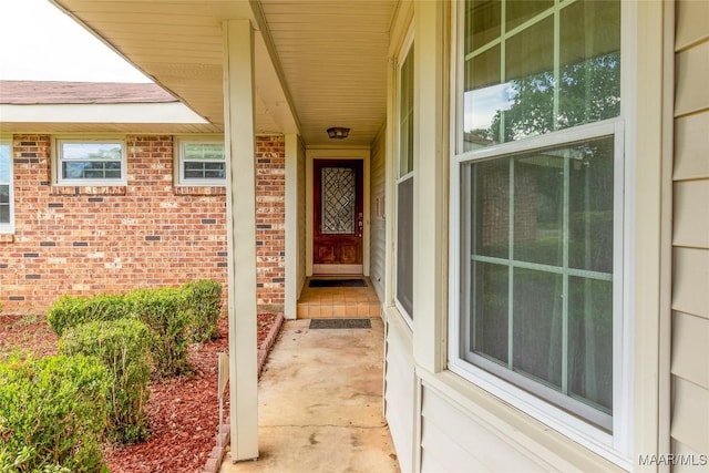 entrance to property featuring brick siding