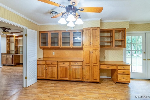 kitchen featuring wallpapered walls, brown cabinetry, ceiling fan, crown molding, and light wood-style floors