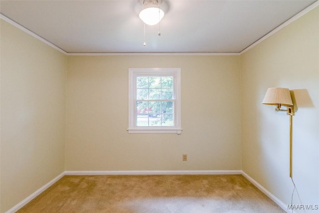 spare room featuring baseboards, light colored carpet, and crown molding