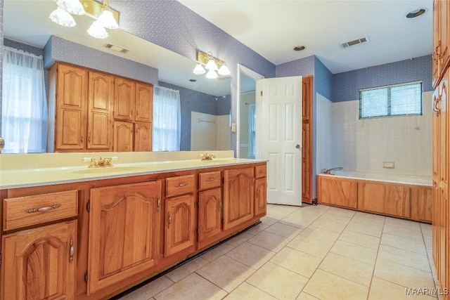 bathroom featuring a washtub, a sink, visible vents, double vanity, and wallpapered walls