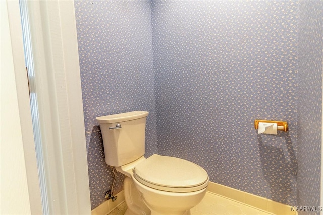 bathroom featuring wallpapered walls, toilet, and tile patterned floors