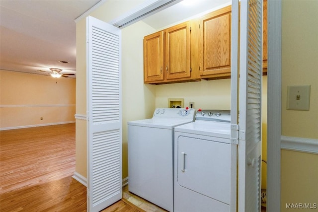 clothes washing area featuring cabinet space, baseboards, a ceiling fan, light wood-style flooring, and independent washer and dryer