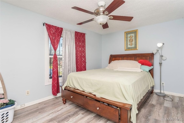 5217 W Shades Valley Dr, Montgomery, AL 36108 - bedroom featuring a textured ceiling, wood finished floors, and baseboards