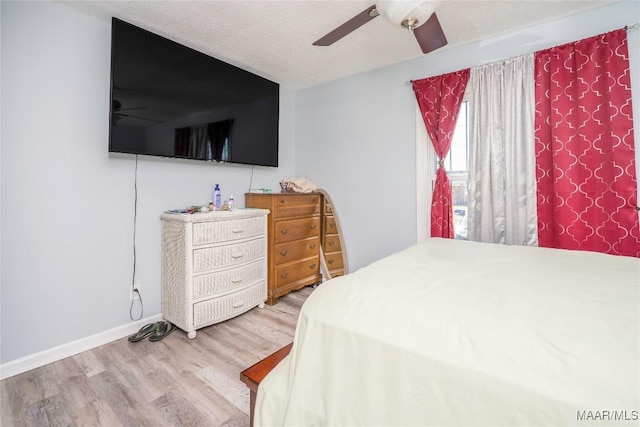 5217 W Shades Valley Dr, Montgomery, AL 36108 - bedroom featuring ceiling fan, a textured ceiling, baseboards, and wood finished floors