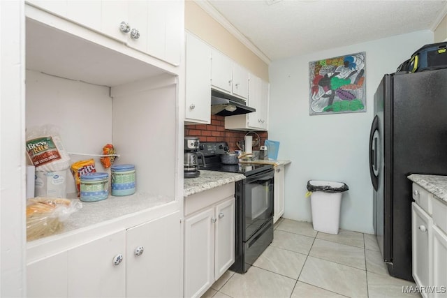5217 W Shades Valley Dr, Montgomery, AL 36108 - kitchen featuring light tile patterned flooring, under cabinet range hood, white cabinetry, black appliances, and tasteful backsplash