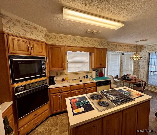 kitchen featuring wallpapered walls, brown cabinetry, light countertops, black appliances, and a sink