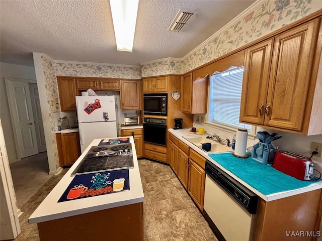 kitchen featuring wallpapered walls, visible vents, light countertops, black appliances, and a sink