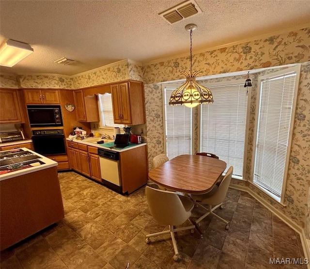 kitchen featuring black appliances, visible vents, and wallpapered walls