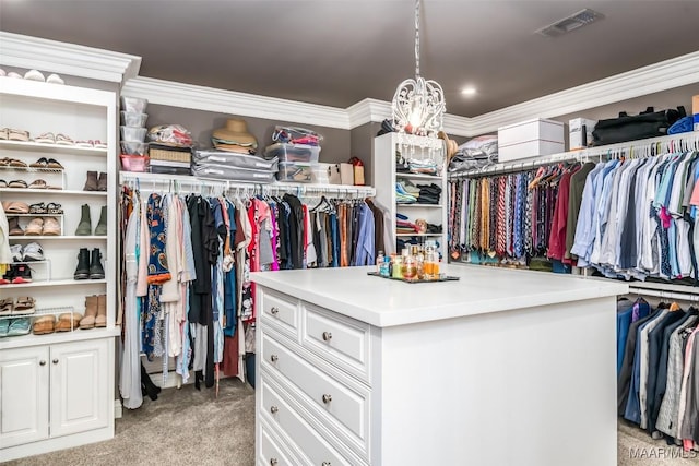 walk in closet with visible vents and light colored carpet