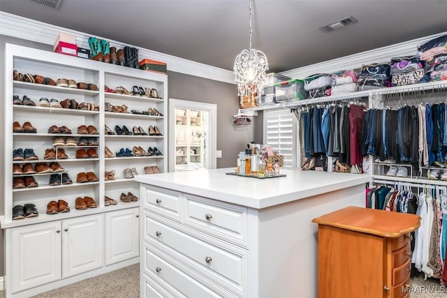 walk in closet with carpet, visible vents, and an inviting chandelier