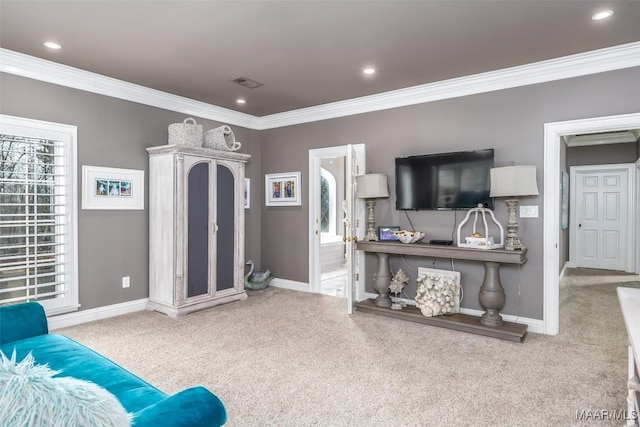 living room with carpet, visible vents, and crown molding