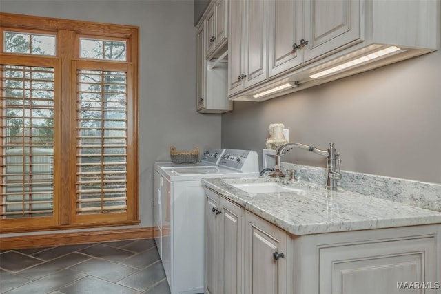 laundry area with a sink, cabinet space, washer and dryer, and tile patterned floors