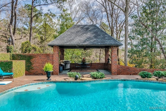 view of pool with fence, a fenced in pool, and a gazebo