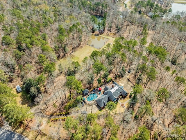 drone / aerial view featuring a water view and a view of trees