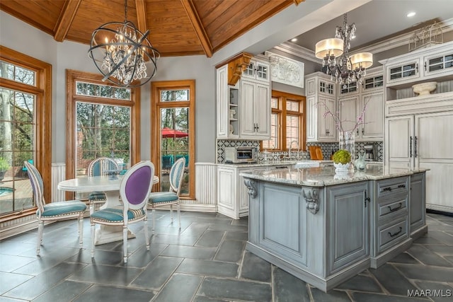 kitchen featuring wooden ceiling, gray cabinetry, and an inviting chandelier