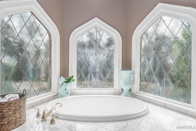 bathroom featuring a garden tub and plenty of natural light