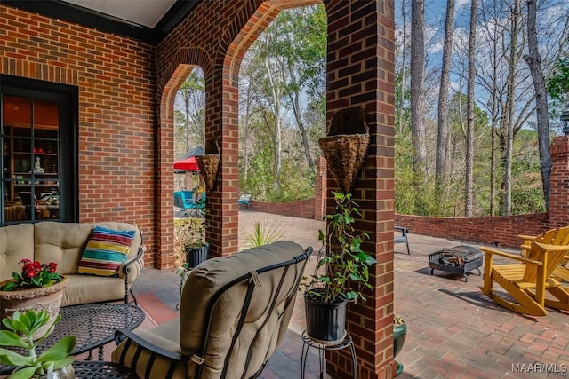 view of patio / terrace featuring an outdoor living space with a fire pit