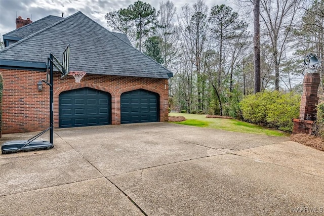 garage featuring concrete driveway