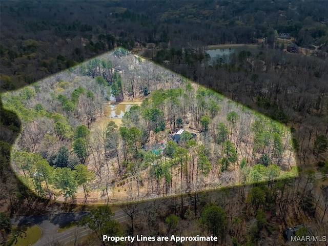 bird's eye view featuring a wooded view