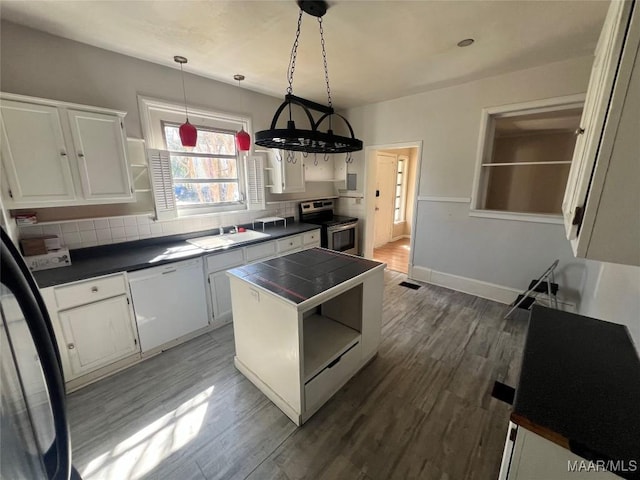 kitchen featuring stainless steel electric range oven, open shelves, tile counters, and white cabinetry