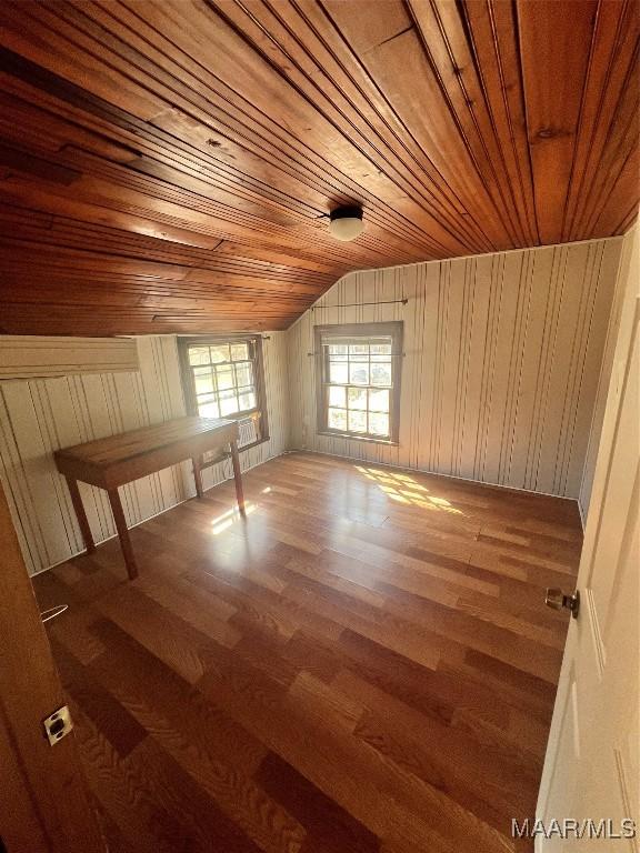 additional living space featuring lofted ceiling, wood finished floors, and wood ceiling