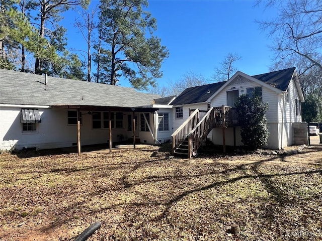 rear view of house with stairs and crawl space