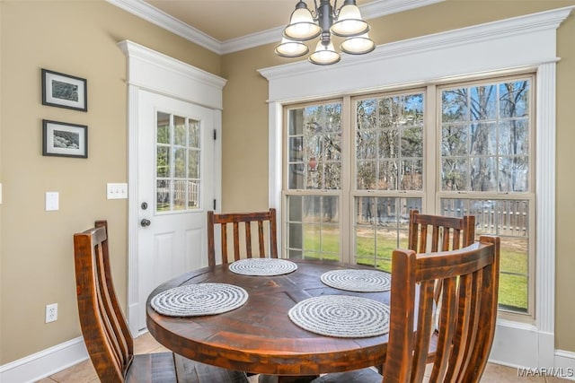 dining space with tile patterned floors, plenty of natural light, a chandelier, and ornamental molding