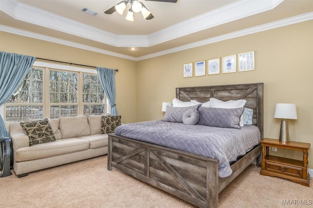 bedroom featuring visible vents, crown molding, a raised ceiling, and carpet floors