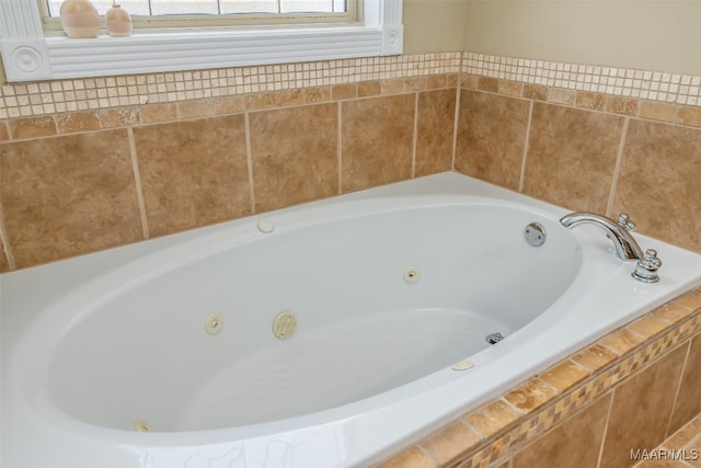 bathroom featuring a tub with jets