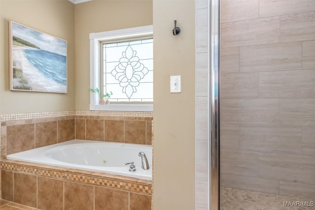 bathroom featuring a jetted tub and a stall shower