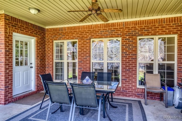 view of patio featuring outdoor dining area and a ceiling fan