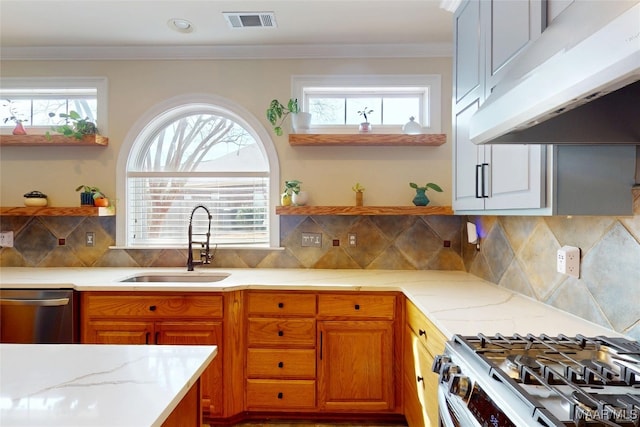 kitchen with visible vents, open shelves, under cabinet range hood, appliances with stainless steel finishes, and a sink