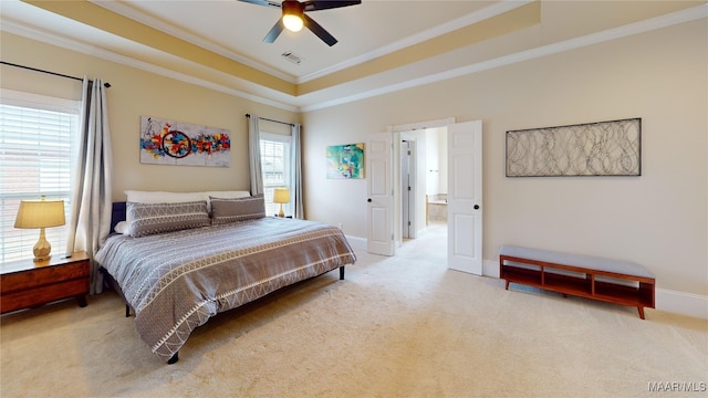 bedroom with a tray ceiling, crown molding, visible vents, and carpet floors