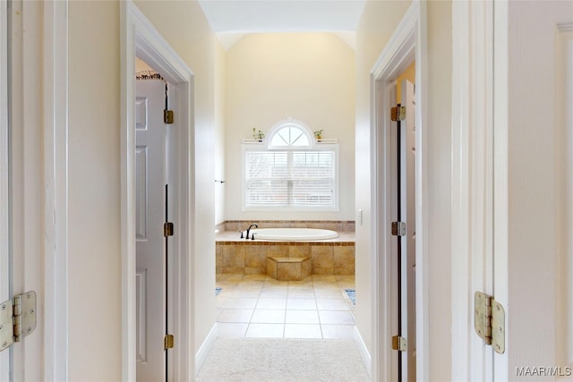 full bath featuring tile patterned floors and a bath