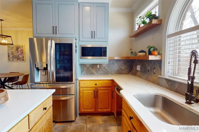 kitchen featuring a sink, backsplash, crown molding, stainless steel appliances, and open shelves