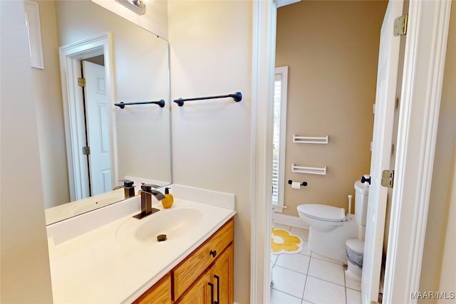 bathroom featuring vanity, tile patterned floors, and toilet