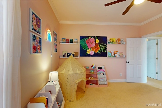 playroom featuring carpet flooring, baseboards, crown molding, and a ceiling fan