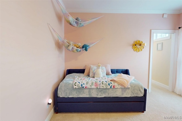 carpeted bedroom featuring baseboards and ornamental molding