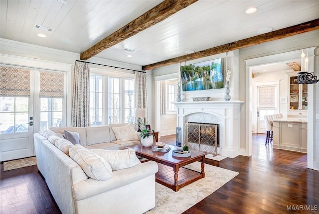 living area with visible vents, dark wood finished floors, beam ceiling, recessed lighting, and a fireplace