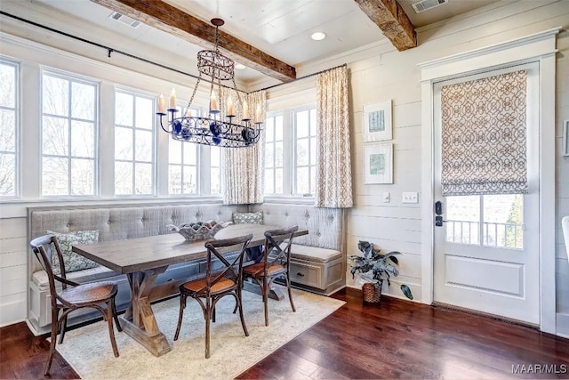 dining room featuring beamed ceiling, visible vents, dark wood finished floors, breakfast area, and a chandelier