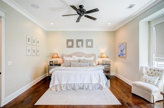 bedroom with dark wood-style floors, visible vents, crown molding, and baseboards