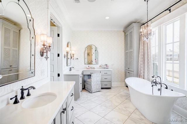 bathroom with two vanities, a sink, a closet, wallpapered walls, and a freestanding bath